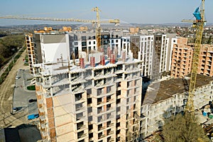 Construction and construction of high-rise buildings, the construction industry with working equipment and workers. View from