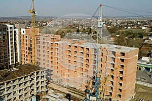 Construction and construction of high-rise buildings, the construction industry with working equipment and workers. View from