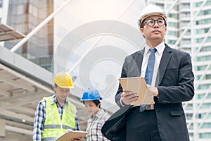 Construction and contractor team working together. Project manager giving consultation to engineers in construction site.