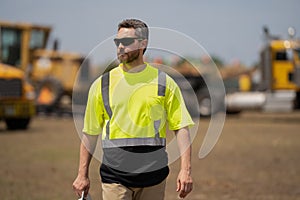 Construction contractor walking and overseeing the building. contractor walking at site of project. Contractor