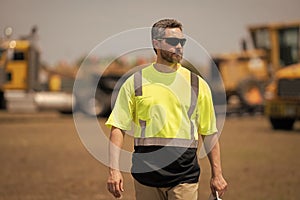 Construction contractor walking and overseeing the building. contractor walking at site of project. Contractor