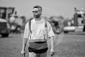 Construction contractor walking and overseeing the building. contractor walking at site of project. Contractor