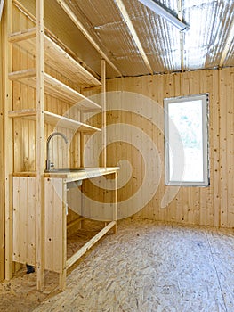 Construction of a country house. Installed homemade yet stylish wood kitchen