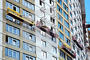 Construction cradles perform facade work.