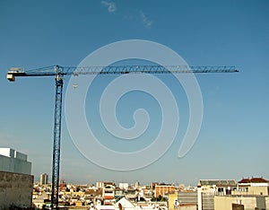 Construction crane above the city. Barcelona, Spain.