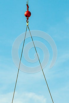 Construction crane, ball and hook with two lengths of chain, lifting heavy equipment