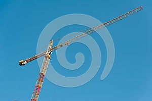 Construction crane on a blue background.