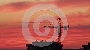 Construction crane in a bright light of sunset