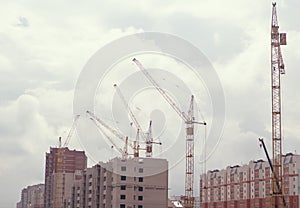 The construction crane and the building against