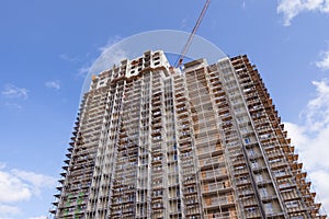 Construction crane building a new high-rise skyscraper or apartment building