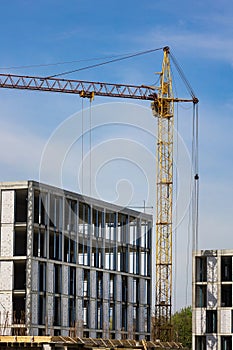 construction crane building real estate against a blue sky background
