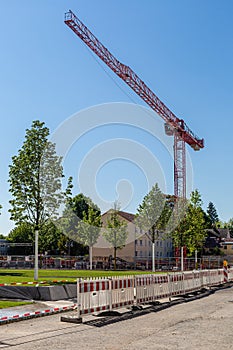 Construction crane on a building site. Construction next to the church. City infrastructure. Construction of a housing estate noah