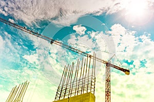 Construction crane building skyscrapers and houses. Crane silhouette on construction site, industrial tools closeup