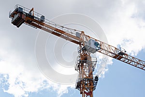 Construction crane cabin close up on the background of the sky. Construction site.