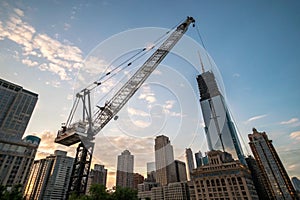 Construction crane elevating materials on building site