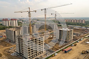 Construction crane on housing site with buildings under construction