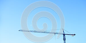 Construction crane isolated against blue sky