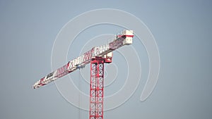 Construction crane isolated on the blue sky background