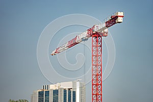 Construction crane isolated on the blue sky background