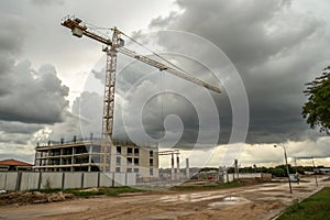Construction crane lifting materials at building site