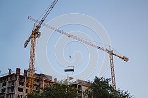 Construction crane moving down building structure