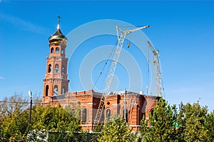 Construction crane near the church under construction