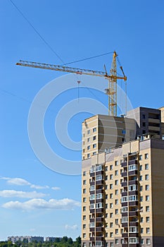 Construction crane near the newly built block of flats