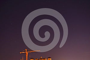 Construction crane in the night sky.