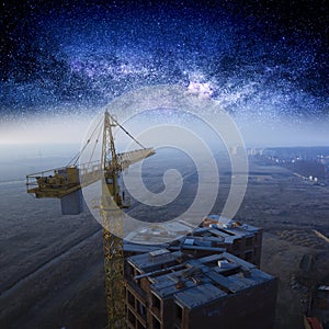 Construction crane, night starry sky and construction site.