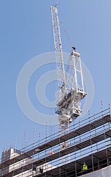 Construction crane scaffolding construction site against a clea