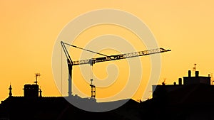 Construction crane silhouette at sunset