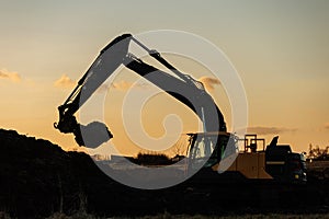 Construction crane silhouette at sunset