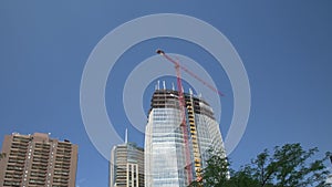 Construction Crane on Skyscraper Time-lapse Wide Shot