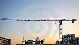 Construction crane, sunset time, Rotterdam, Netherlands