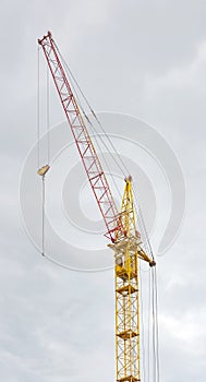 Construction crane tower against a blue sky.