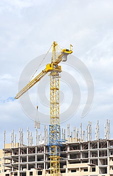 Construction crane tower against a blue sky.