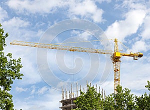 Construction crane tower against a blue sky.