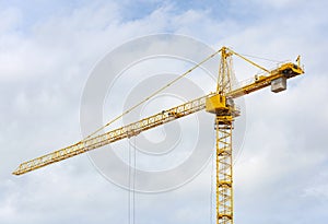 Construction crane tower against a blue sky.