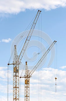 Construction crane tower against a blue sky.