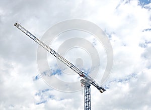 Construction crane tower against a blue sky.