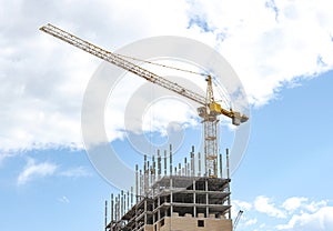 Construction crane tower against a blue sky.