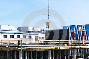 Construction crane tower on blue sky background. Crane and building working progress. Worker. Empty Space for text. Construction c