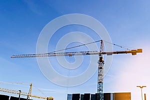 Construction crane tower on blue sky background. Crane and building working progress. Worker. Empty Space for text. Construction c