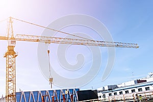 Construction crane tower on blue sky background. Crane and building working progress. Worker. Empty Space for text. Construction c