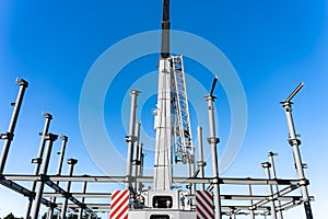 Construction crane towering over structural steel framing