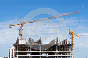 Construction crane and worker of building industry with blue sky
