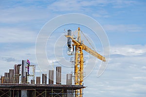 Construction crane and worker of building industry with blue sky