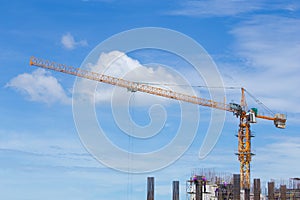 Construction crane and worker of building industry with blue sky