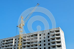 Construction cranes on a background of blue sky