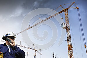 Construction cranes and building worker